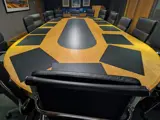 Boardroom with large oval table and executive seating