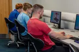 Apprentices working on engineering design software in classroom