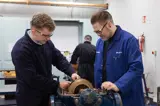 EKGTA engineering instructor guiding an apprentice during a mechanical maintenance training session.